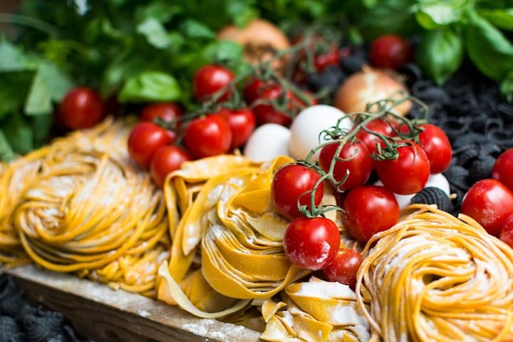 A vibrant display of seasonal Italian ingredients, including fresh herbs, vegetables, and ripe tomatoes, highlighting the essence of Italian cooking.